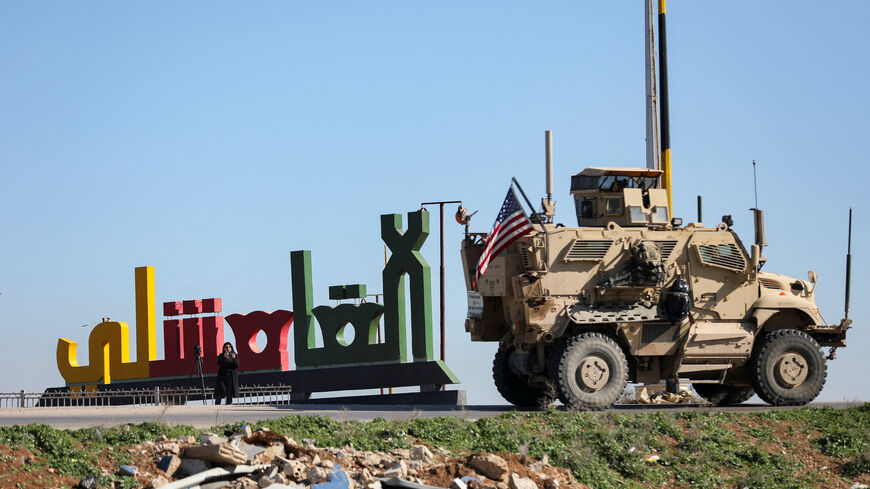 An armoured U.S. military vehicle with a U.S. flag on it moves towards the Iraqi Kurdistan region, withdrawing from Qasrak military base in northeastern Syria, in Qamishli, Syria, February 23, 2026. REUTERS/Orhan Qereman