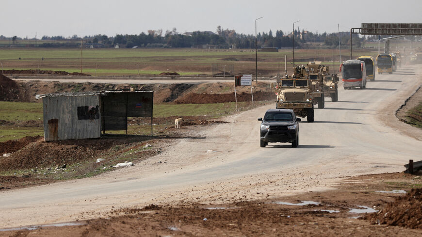 FILE PHOTO: U.S. military vehicles move ahead of buses transporting Islamic State detainees from Syria to Iraq, according to a security source from the Syrian Democratic Forces, in Qamishli, Syria, February 8, 2026. REUTERS/Orhan Qereman/File Photo