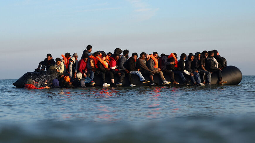 A group of migrants on an inflatable dinghy leave the beach of Petit-Fort-Philippe in northern France in an attempt to cross the English Channel to reach Britain, in Gravelines, near Calais, France, September 27, 2025. REUTERS/Abdul Saboor/File Photo