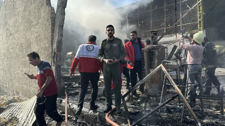 Rescue forces work at the site of an Iranian army helicopter crash in a fruit market in Isfahan, Iran, February 24, 2026. Iranian Red Crescent/WANA (West Asia News Agency)/Handout via REUTERS