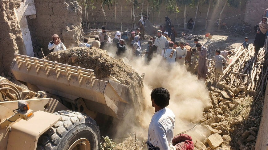FILE PHOTO: Residents gather as machinery clears the debris of a damaged house, following the Pakistani air strikes, in Nangarhar, Afghanistan, February 22, 2026. REUTERS/Stringer/File Photo