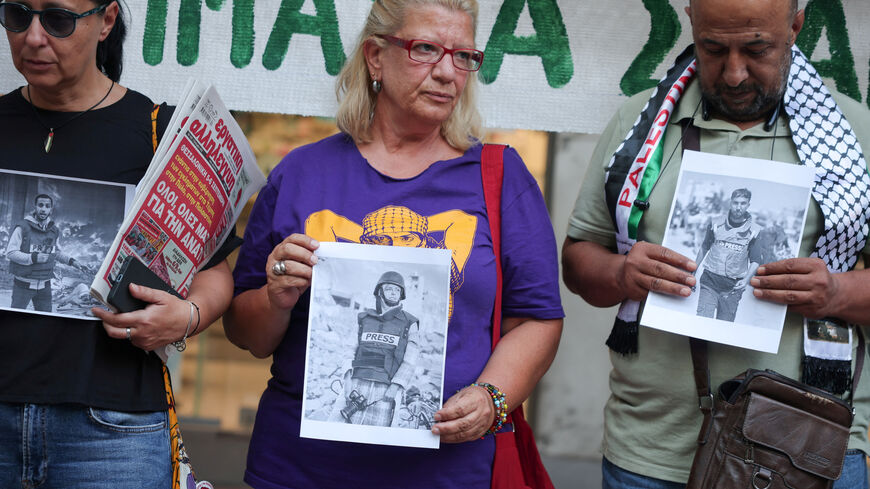 Greek and foreign journalists hold pictures of recently killed journalists in Gaza, during a protest outside the Union of Greek Journalists in Athens, Greece, September 4, 2025. REUTERS/Louisa Gouliamaki