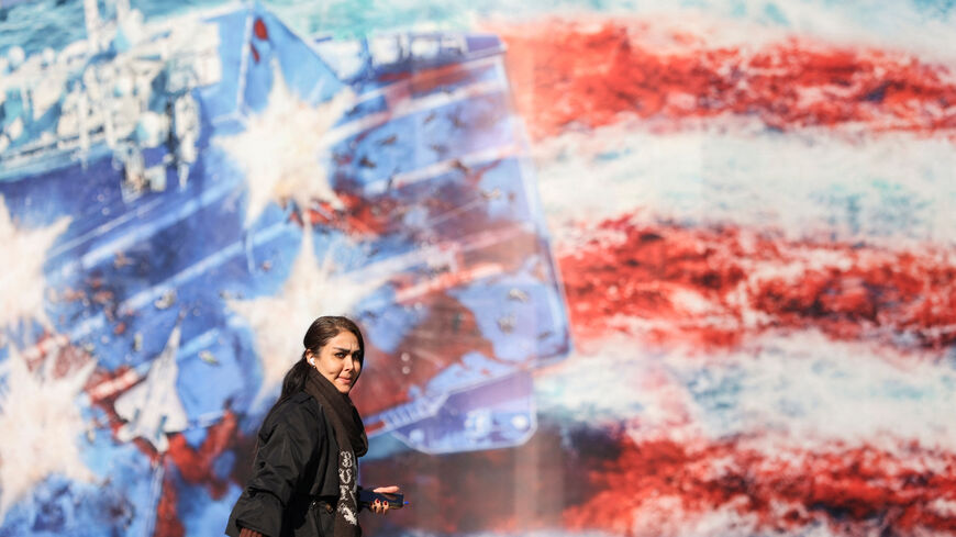 A woman walks past an anti-U.S. billboard on a street in Tehran, Iran, February 17, 2026. Majid Asgaripour/WANA (West Asia News Agency) via REUTERS