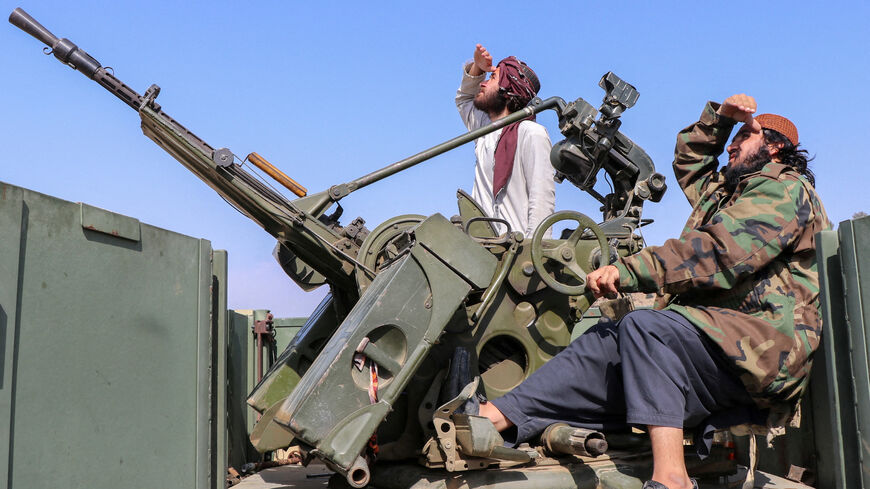 Taliban soldiers sit next to an anti-aircraft gun while on lookout for Pakistan's fighter jets, in Khost province, Afghanistan, February 27, 2026. REUTERS/Stringer