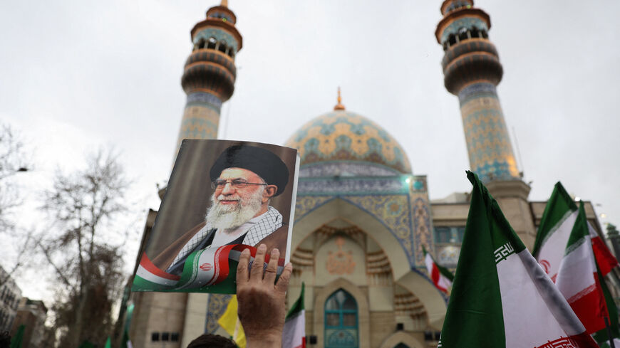 A person holds an image of  Iran's Supreme Leader Ayatollah Ali Khamenei  as Iranian demonstrators protest against the U.S.-Israeli strikes, in Tehran, Iran, February 28, 2026. Majid Asgaripour/WANA (West Asia News Agency) via REUTERS