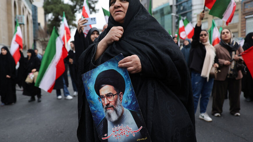 A woman holds an image of Iran's Supreme Leader Ayatollah Ali Khamenei as Iranian demonstrators protest against the U.S.-Israeli strikes, in Tehran, Iran, February 28, 2026. Majid Asgaripour/WANA (West Asia News Agency) via REUTERS