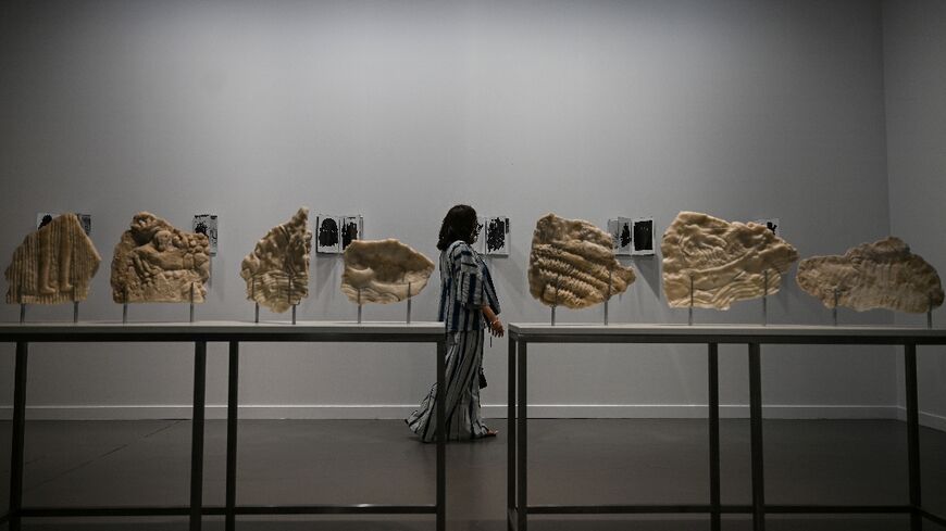 A visitor exploring the Art Basel Qatar exhibition space