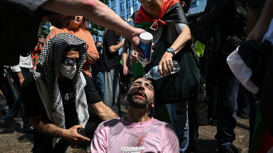A protester is helped after police deployed pepper spray to disperse demonstrators taking part in a Pro-Palestinian rally against Israeli President Isaac Herzog's visit to Australia in Sydney on February 9, 2026
