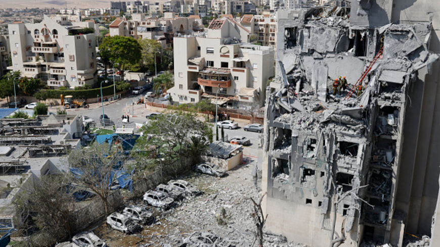 Emergency workers check the damage caused to a building from an Iranian missile strike in Beersheba in southern Israel on June 24, 2025. Israel said on June 24 it had agreed to US President Donald Trump's proposal for a ceasefire with Iran, on the 12th day of war between the foes. (Photo by John Wessels / AFP) (Photo by JOHN WESSELS/AFP via Getty Images)