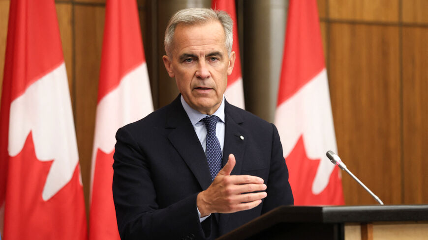 Canadian Prime Minister Mark Carney speaks during a press conference after a Cabinet meeting to discuss both trade negotiations with the US and the situation in the Middle East, at the National Press Theatre in Ottawa, Ontario, Canada on July 30, 2025. Canada "intends" to recognize a Palestinian state at the UN General Assembly in September, Prime Minister Mark Carney said Wednesday, a dramatic policy shift he said was necessary to preserve hopes of a two-state solution. (Photo by Dave CHAN / AFP) (Photo by