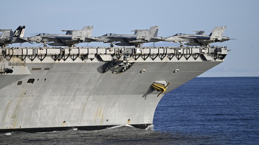 DENMARK-NORWAY-US-FRANCE-NATO-ARMY-DEFENCE-EXERCISE Picture taken on September 24, 2025 from the French Navy frigate Bretagne shows F-18 fighter jets on the deck of the the world's largest aircraft carrier USS Gerald R Ford as both ships are taking part in the NATO Neptune Strike 2025 exercise in the North Sea. According to NATO, more than 10,000 sailors, soldiers, aviators and marines from 13 allied nations took part in the large-scale multinational enhanced Vigilance Activity, running from September 22 to
