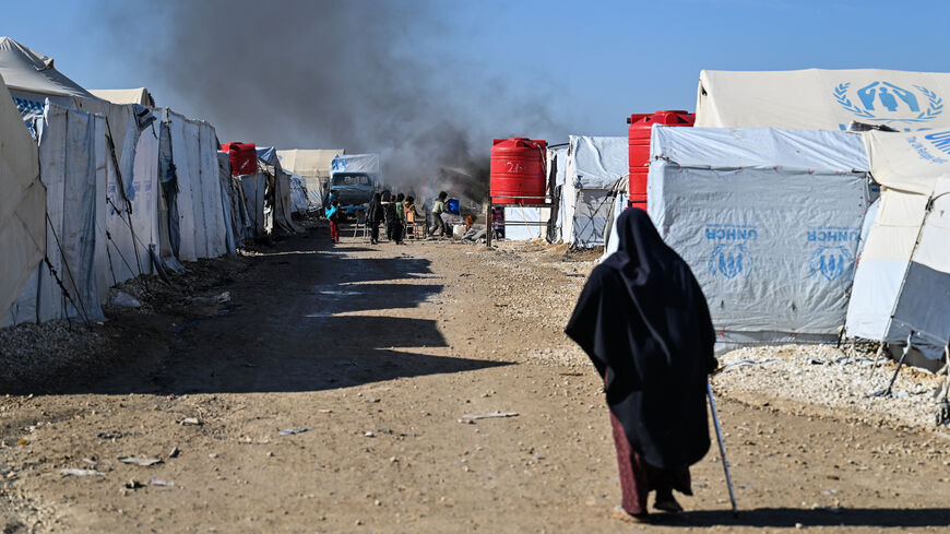 A campfire burns inside al-Hol camp on Jan. 26, 2026 in Al Hasakah, Syria. 