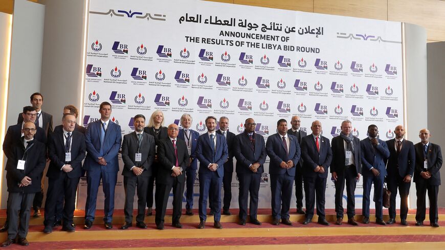Masoud Suleman, acting chairman of Libya's National Oil Corporation, and other corporate representatives pose for a photo during a conference announcing the first new grants of oil exploration and production licenses in 17 years, in Libya's capital, Tripoli, on Feb. 11, 2026. 