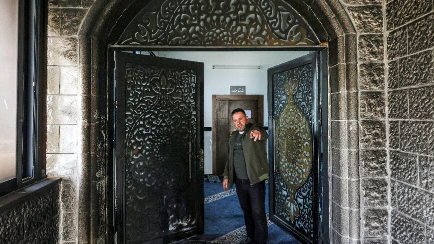 The burnt entrance of the Abu Bakr al-Siddiq Mosque in the West Bank village of Tell