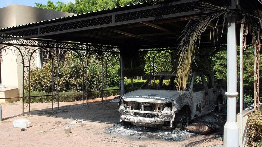 The wreckage of a car sits inside the US Embassy compound on September 12, 2012 in Benghazi, Libya, following an overnight attack on the building