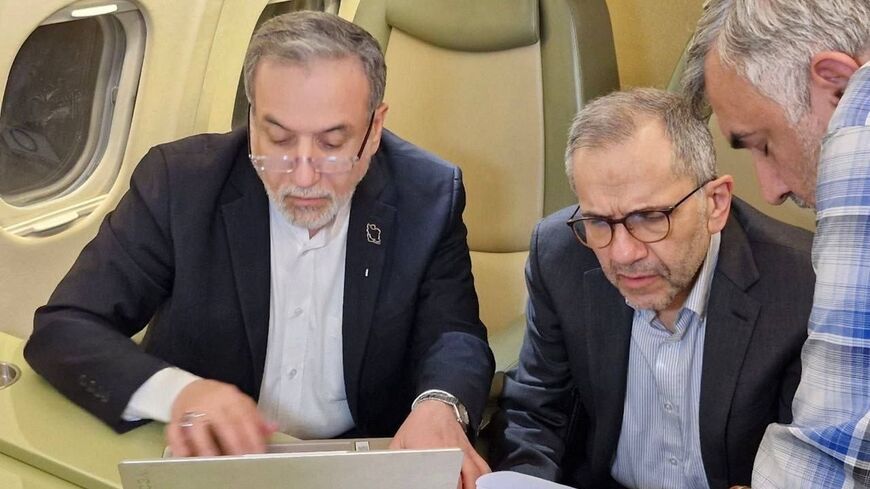Iranian Foreign Minister Abbas Araghchi (L) and Deputy Foreign Minister for Political Affairs Majid Takht-Ravanchi on a flight to Muscat, Oman, to participate in talks with the US over Tehran's nuclear program, Feb. 5, 2026. 