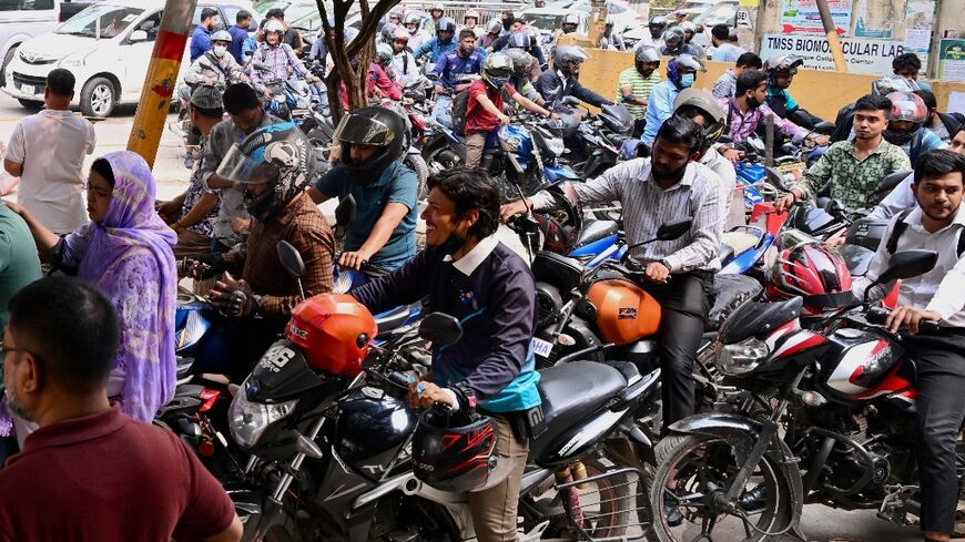 People queue up to refuel their motorbikes at a gas station in Dhaka. Around seven million Bangladeshis work overseas -- the majority in the Middle East, with Saudi Arabia hosting around two-thirds of the total