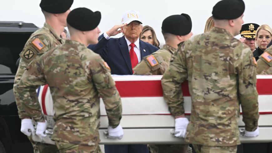 US President Donald Trump salutes as the remains of Sergeant First Class Noah Tietjens, killed in the war with Iran, arrive at Dover Air Force Base on March 7, 2026