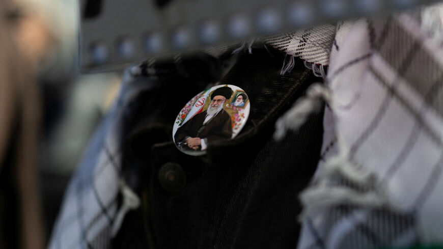 A protester wears a badge depicting late Iran's Supreme Leader Ayatollah Ali Khamenei during an anti-war demonstration following strikes on Iran, in Athens, Greece, March 1, 2026. REUTERS/Stelios Misinas