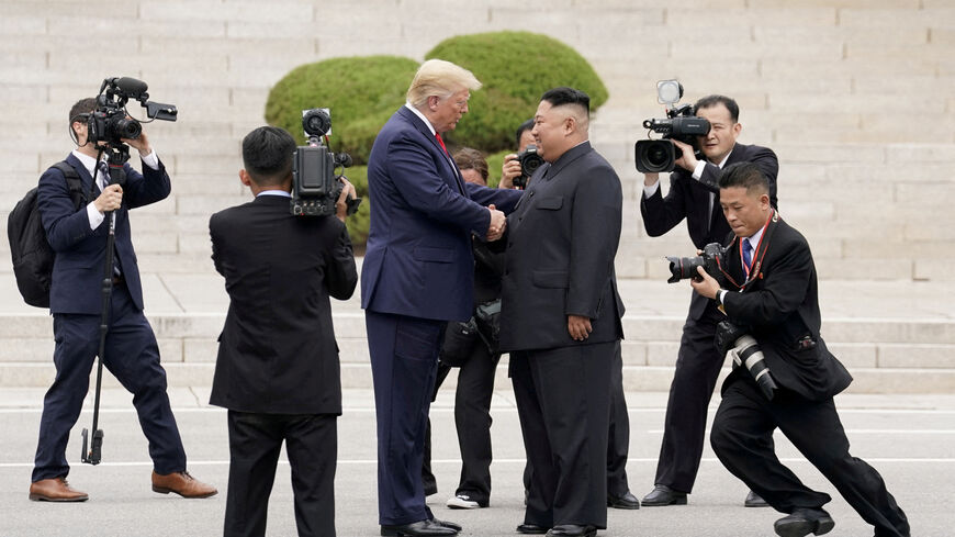 FILE PHOTO: U.S. President Donald Trump meets with North Korean leader Kim Jong Un at the demilitarized zone separating the two Koreas, in Panmunjom, South Korea, June 30, 2019. REUTERS/Kevin Lamarque/File Photo