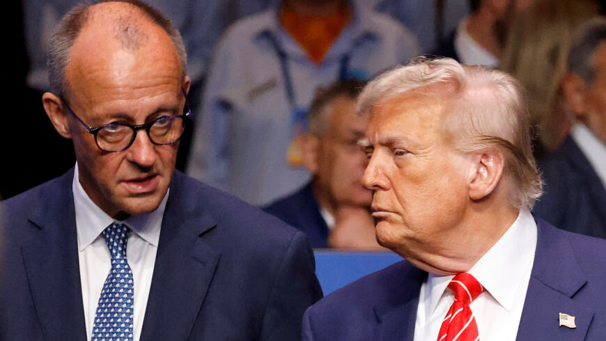 Germany's Chancellor Friedrich Merz speaks with US President Donald Trump before the start of the North Atlantic Council plenary meeting at the North Atlantic Treaty Organisation (NATO) summit in The Hague on June 25, 2025.      LUDOVIC MARIN/Pool via REUTERS/File Photo