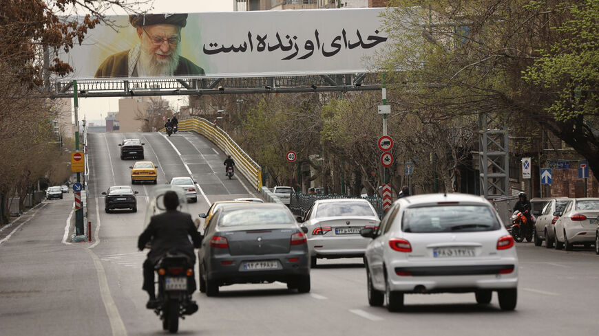 People drive near a banner of Iran's late Supreme Leader Ayatollah Ali Khamenei on a street, after he was killed in Israeli and U.S. strikes on Saturday, in Tehran, Iran, March 2, 2026. Majid Asgaripour/WANA (West Asia News Agency) via REUTERS