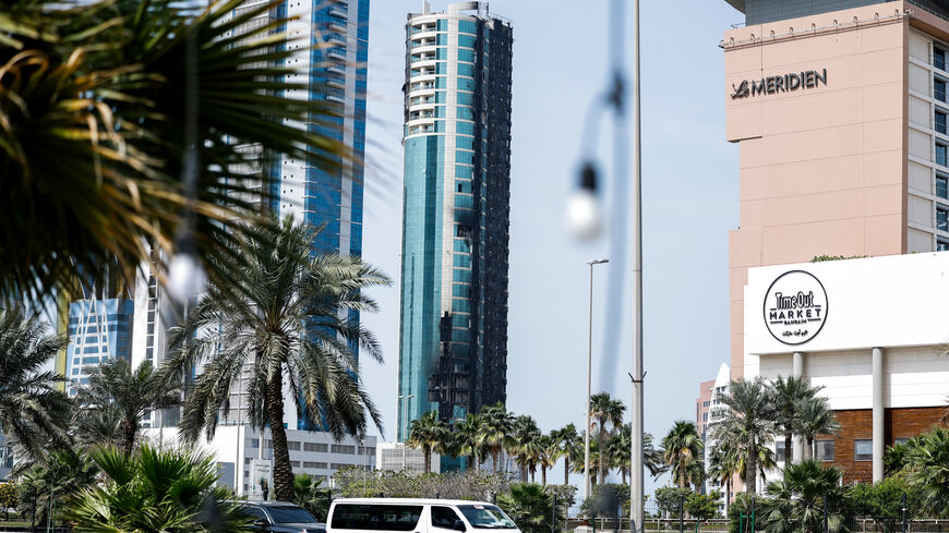 Vehicles drive past a building that was damaged by an Iranian drone attack, after Israel and the U.S. launched strikes on Iran, in Seef, Manama, Bahrain, March 1, 2026. REUTERS/Hamad I Mohammed