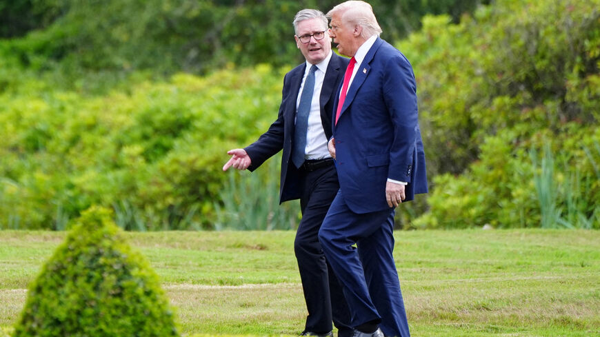 FILE PHOTO: U.S. President Donald Trump walks with British Prime Minister Keir Starmer at Trump International Golf Links, in Aberdeen, Scotland, Britain, July 28, 2025.    Jane Barlow/Pool via REUTERS/File Photo