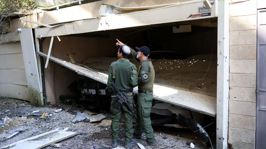 Israeli military members work at the site of an Iranian missile strike, amid the U.S.-Israel conflict with Iran, in Petah Tikva, Israel March 3, 2026. REUTERS/Ronen Zvulun