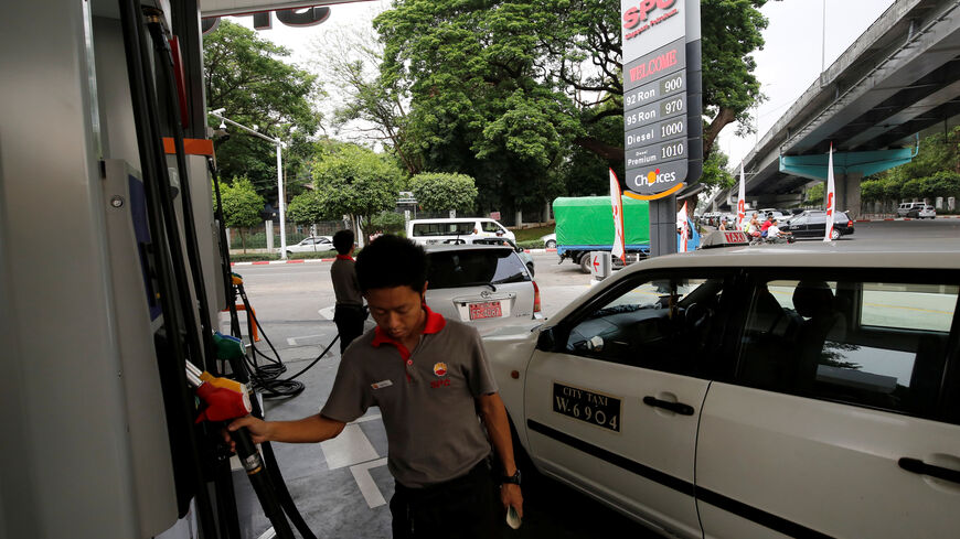 FILE PHOTO: A worker tends to a customer at a Singapore Petroleum Company (SPC) fuel station in Yangon, Myanmar, May 9, 2019. REUTERS/Ann Wang/File Photo
