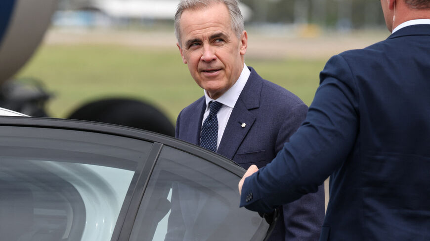 Canadian Prime Minister Mark Carney reacts as he enters a vehicle at Sydney Kingsford Smith Airport in Sydney, Australia, March 3, 2026. REUTERS/Hollie Adams