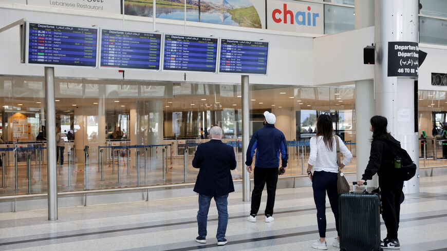 Passengers look at flight information boards at Beirut–Rafic Hariri International Airport, following an escalation between Hezbollah and Israel, amid the U.S.-Israel conflict with Iran, in Beirut, Lebanon, March 4, 2026. REUTERS/Khalil Ashawi