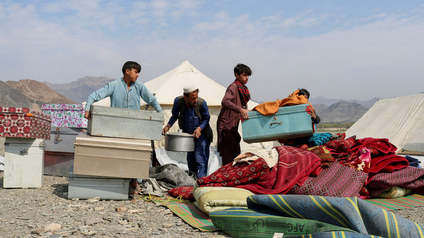 FILE PHOTO: A displaced Afghan family who fled following exchanges of fire between Pakistani and Afghan forces at a border crossing arranges their belongings in a makeshift camp as they take refuge in Lal Pur district in eastern Nangarhar province, Afghanistan, March 4, 2026. REUTERS/Stringer/File Photo