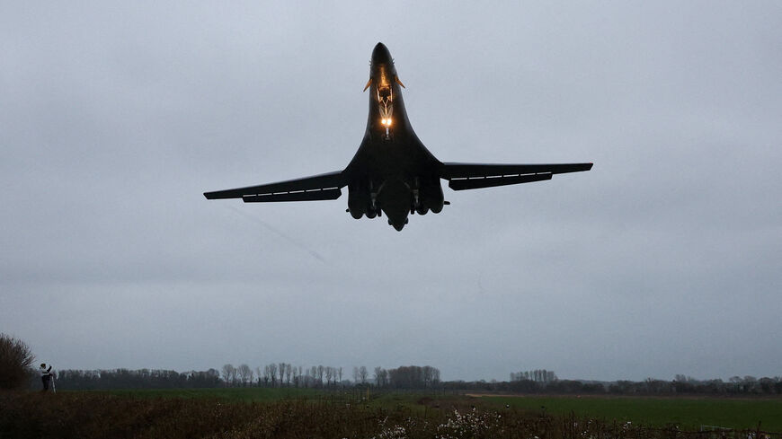 A person looks up as a USAF B1-B bomber prepares to land at RAF Fairford airbase, which also hosts United States Air Force (USAF) personnel, amid the U.S.–Israeli conflict with Iran, in Fairford, Britain, March 6, 2026. REUTERS/Toby Melville