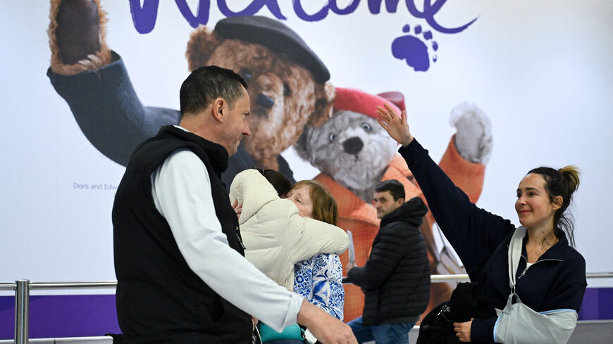 A passenger from an Oman Air flight which departed from Muscat, Oman, is welcomed upon arrival at Heathrow International Airport, amid the U.S.-Israeli conflict with Iran, in London, Britain, March 6, 2026. REUTERS/Jaimi Joy