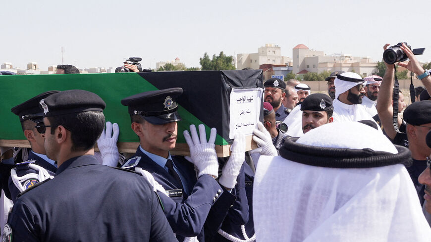 Guards of Honour carry the coffin of one of two police officers, who were killed while performing their duties, during their funeral procession at a graveyard in Kuwait City, Kuwait, March 9, 2026. REUTERS/Mohammed Benmansour