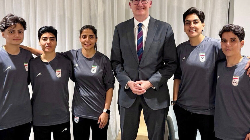 Australia’s Home Affairs Minister Tony Burke poses with Fatemeh Pasandideh, Mona Hamoudi, Atefeh Ramezanizadeh, Zahra Ghanbari and Zahra Sarbali, the five women from the Iranian women’s soccer team who were granted humanitarian visas, in Queensland, Australia, March 9, 2026. @Tony_Burke on X/Handout via REUTERS