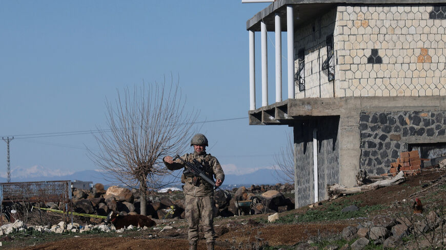 A Turkish soldier stands guard as army and security personnel search a field after a piece of ammunition fell following the interception of a missile launched from Iran by a NATO air defence system, in Diyarbakir, Turkey, March 9, 2026. REUTERS/Sertac Kayar