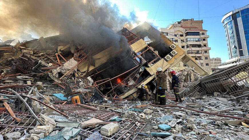 Members of the Lebanese Civil Defence inspect a damaged building after an Israeli strike on Beirut's southern suburbs, following renewed hostilities between Hezbollah and Israel amid the U.S.-Israeli conflict with Iran, Lebanon, March 9, 2026. Picture taken with a mobile phone. REUTERS/Stringer
