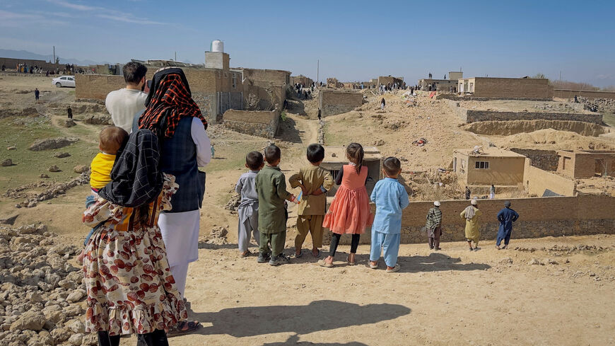 Children stand near a house damaged in what the Taliban said was a Pakistani air strike on the outskirts of Kabul, Afghanistan, March 13, 2026. Picture taken with a mobile phone. REUTERS/Sayed Hassib