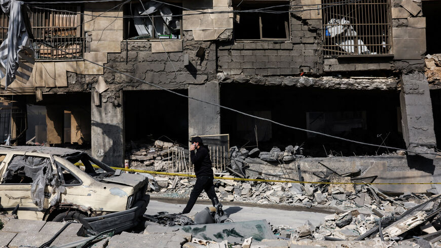 A man walks past a damaged building in the aftermath of yesterday's Israeli strikes on Bachoura neighbourhood, following an escalation between Hezbollah and Israel amid the U.S.-Israeli conflict with Iran, Lebanon, March 13, 2026. REUTERS/Mohamed Azakir