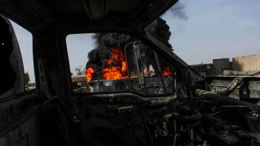 Thick black smoke is seen through a destroyed truck at the private airline Kam Air's fuel depot after a strike in what the Taliban said was a Pakistani air strike, in Kandahar, Afghanistan, March 13, 2026. REUTERS/Stringer