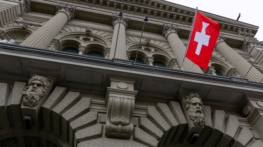 FILE PHOTO: A Swiss flag hangs at the Swiss Parliament building (Bundeshaus) in Bern, Switzerland, March 12, 2025. REUTERS/Denis Balibouse/File Photo