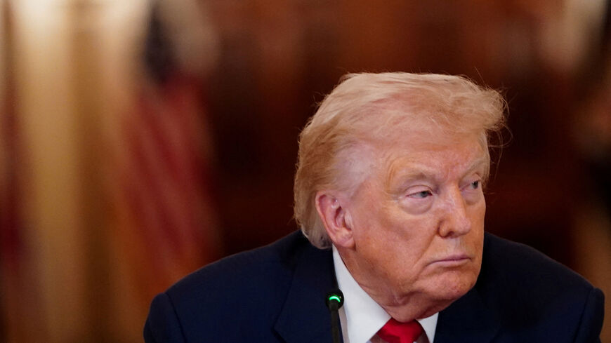 FILE PHOTO: U.S. President Donald Trump looks on during a round table on collegiate sports in the White House in Washington, D.C., March 6, 2026. REUTERS/Nathan Howard/File Photo