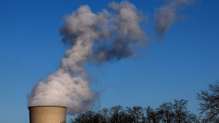 FILE PHOTO: Smoke billows from a chimney at a combined-cycle gas turbine power plant in Drogenbos, Belgium January 16, 2024. REUTERS/Yves Herman/File Photo