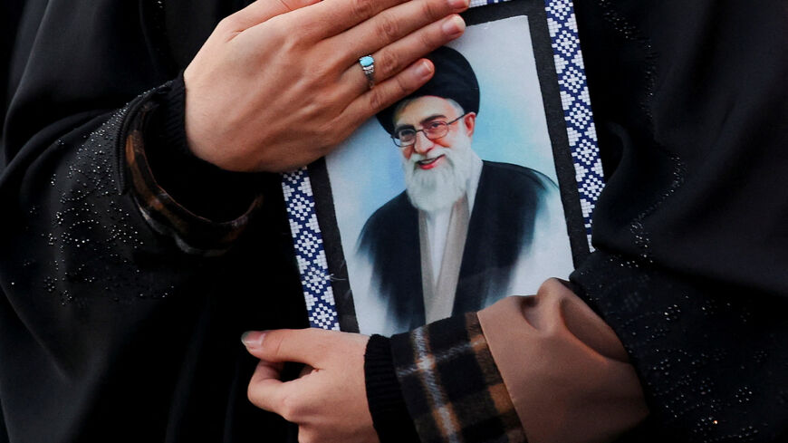 A woman holds on to a picture of Iran's Supreme Leader Ayatollah Ali Khamenei at the Enghelab Square, after he was killed in Israeli and U.S. strikes on Saturday, in Tehran, Iran, March 1, 2026. Majid Asgaripour/WANA (West Asia News Agency) via REUTERS