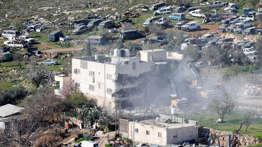 FILE PHOTO: Heavy machinery demolishes a Palestinian building near Hebron in the Israeli-occupied West Bank, February 18, 2026. REUTERS/Mussa Qawasma/File Photo