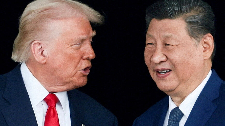 FILE PHOTO: U.S. President Donald Trump and Chinese President Xi Jinping talk as they leave after a bilateral meeting at Gimhae International Airport, on the sidelines of the Asia-Pacific Economic Cooperation (APEC) summit, in Busan, South Korea, October 30, 2025. REUTERS/Evelyn Hockstein/File Photo
