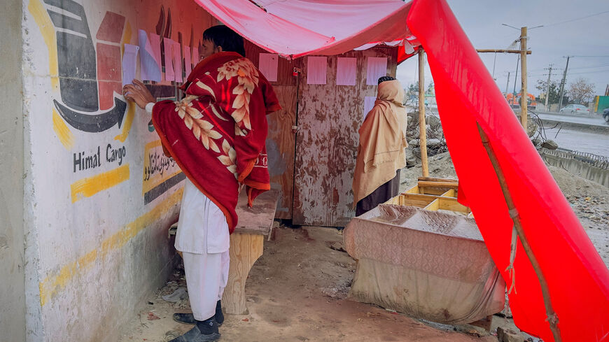 Afghan men search for the names of missing relatives on a list at the site of a drug rehabilitation center destroyed in what the Taliban said was a Pakistani airstrike in Kabul, Afghanistan, March 18, 2026. REUTERS/Sayed Hassib