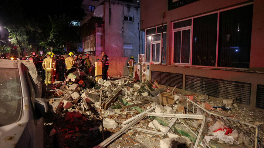 Emergency personnel inspect damage in a building following an Iranian projectile strike, amid the U.S.-Israeli conflict with Iran,  in Ramat Gan, Israel, March 18, 2026. REUTERS/Nir Elias